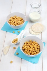 Corn flakes in bowl and  milk on a white background