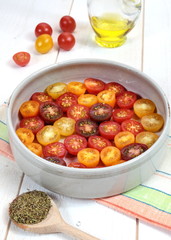 Multicolored cherry tomatoes, Provencal herbs, olive oil for roa