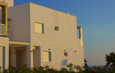 Fototapeta na wymiar Color white modern house at sunset