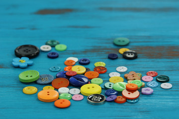 Bright colored buttons on a rustic blue wooden background