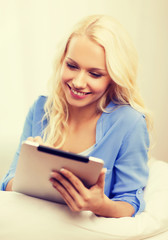 smiling woman with tablet pc computer at home