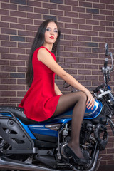 Girl in red dress on a motorcycle