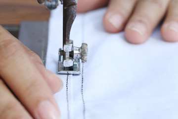 woman working with sewing machine.