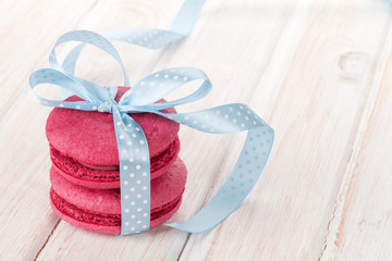 Red macarons with blue ribbon