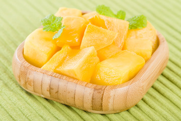 Mango - Pieces of mango in a square bamboo bowl