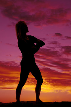 silhouette of a woman arms folded standing