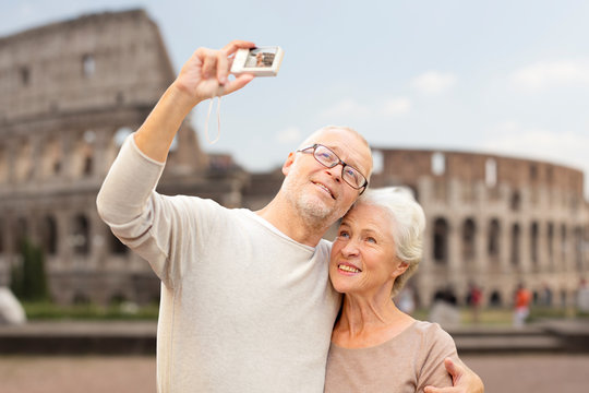 senior couple photographing over coliseum