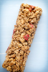 Muesli bars, cereal bars on the wooden background.