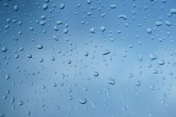 Close-up of water drops on blueish glass