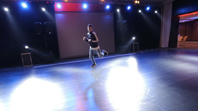 Hip-hop dancer  dances on stage in the club