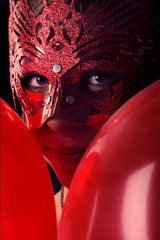 Beautiful girl in a mask and carnival decorations