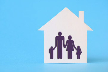 White paper house on blue with family symbol