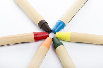 Colour pencils on white background close up