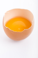 Raw egg close-up on white background
