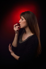 beautiful woman eating red apple