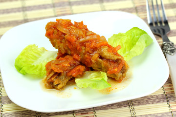 Greek juicy fish on green lettuce