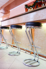 Chairs in row in bar