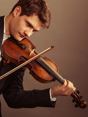 Man violinist playing violin. Classical music art