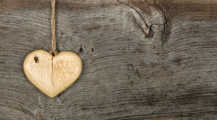 Love Valentines message wooden heart sign on rough grey backgrou