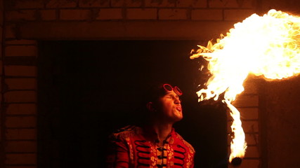 Fire show artist breathe fire in the dark