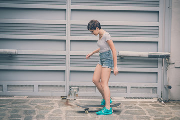 young hipster woman with skate