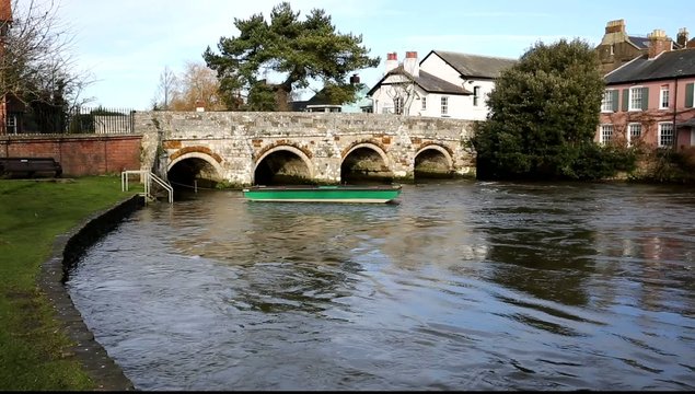 River Avon flowing Christchurch Dorset England UK with bridge
