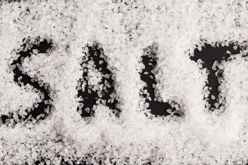 The word salt written into a pile of white granulated salt