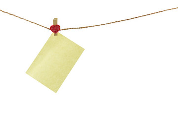 Blank paper note hanging on rope .
