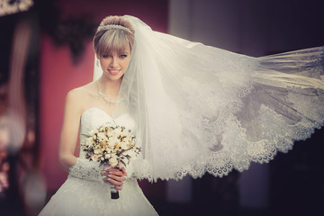 Portrait of a beautiful blonde bride with wedding bouquet