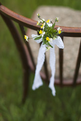 Vintage chair with a floral arrangement for wedding ceremony