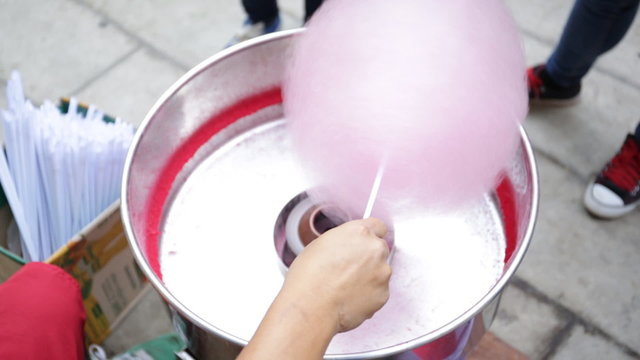 Machine making cotton candy at the festival.