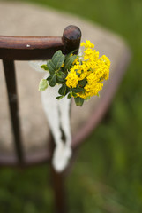 Vintage chair with a floral arrangement for wedding ceremony