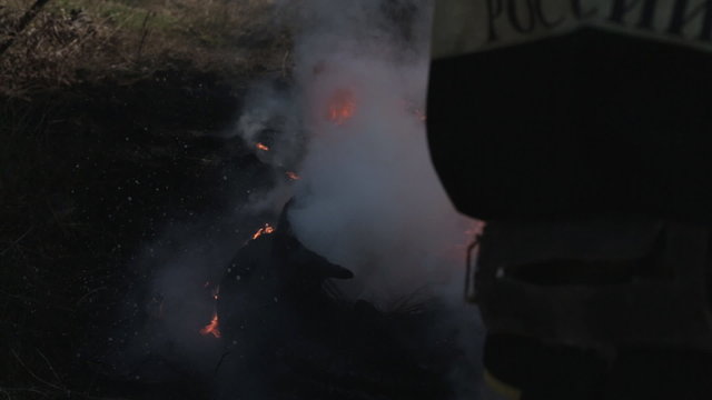 Fireman extinguishes the fire with a water jet