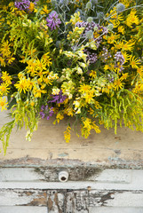 Fototapeta na wymiar Luxuriant wildflowers bouquet on the old vintage table