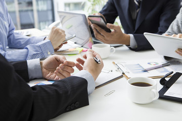 The hands of people who have a meeting