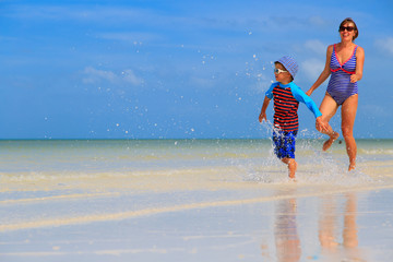 Fototapeta premium mother and son running on the beach