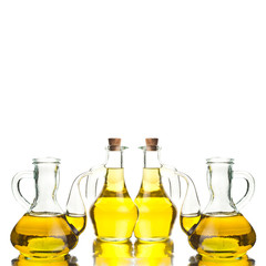 Four glass bottles with extra olive oil