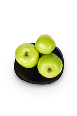 Apples on a black plate