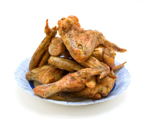 Fried chicken wings on a blue plate isolated on white background