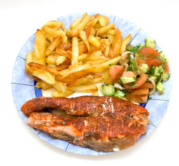 Fried salmon and potatoes with fresh vegetable salade