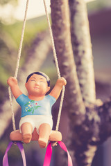 Clay doll on a swing, Vintage color