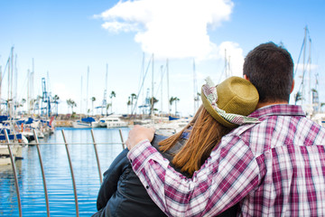 Fototapeta premium Young woman and young man on a marina