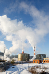 Day view of power plant, smoke from the chimney