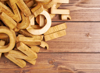 Pile of wooden letters over the wooden surface