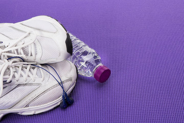 Fitness background with copy space, sneakers and headphones