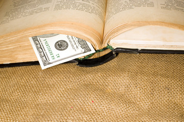 Open book with a bookmark is on sacking