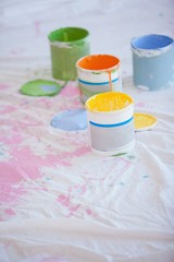 Different paint cans on the floor