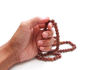 Hand with rosary isolated on white background