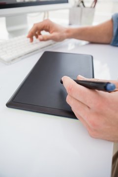 Designer typing on keyboard and using digitizer