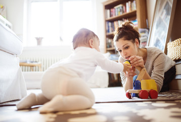 Little baby girl playing with her mother